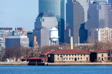 A closeup of Lower Manhattan's Financial District seen behind Ellis Island. Photo taken on March 6, 2016.のeditorial素材