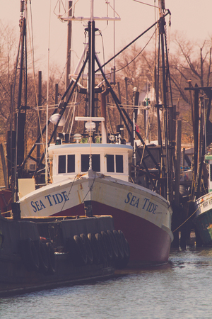 BELFORD, NEW JERSEY - April 11, 2017: The Sea Tide fishing boat is docked at the Belford Seafood...