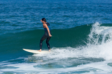 DEAL, NEW JERSEY - September 16, 2017: Surfers enjoy the  surfing the rough surf created by Tropical...