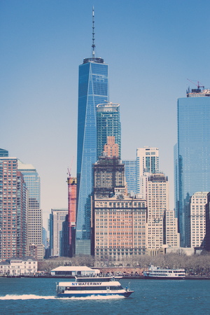 NEW YORK, NEW YORK - March 29, 2017: A NY Waterway ferry boat travels near the World Trade Center in Manhattan's financial district.のeditorial素材
