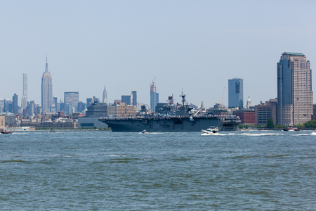 MAY 25, 2016 - Jersey City, NJ:  The USS Bataan Aircraft Carrier travels the Hudson River between Jersey City and Manhattan during the Parade of Ships for Fleet Week, 2016.のeditorial素材