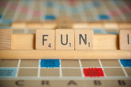 WOODBRIDGE, NEW JERSEY - October 9, 2018: A vintage Scrabble board game is shown with letter tiles spelling out fun.のeditorial素材