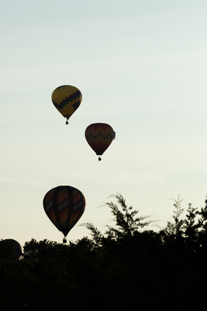 BRANCHBURG, NEW JERSEY - July 28, 2018: The silhouettes of several hot air balloons can be seen along Readington Road after launching at the Quick Chek Festival of Ballooning.のeditorial素材