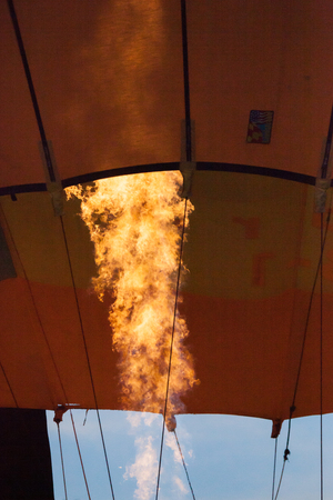 BRANCHBURG, NEW JERSEY - July 28, 2018: Hot air balloons land near next to the Midland School after launching at the Quick Chek Festival of Ballooning. A closeup of the propane flame is seen in this image.のeditorial素材