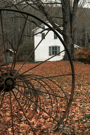 A vintage farm till sits ouside a colonial house during autumn.のeditorial素材