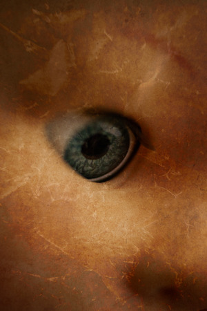 A closeup image of a creepy doll's eyeball.の写真素材