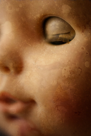 A closeup image of a face on a creepy doll, perfect for Halloween.の写真素材