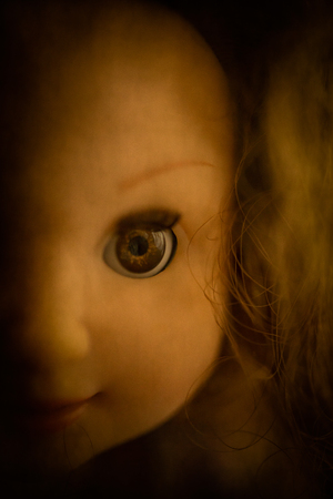 A closeup image of a face on a creepy doll, perfect for Halloween.の写真素材