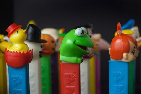 WOODBRIDGE, NEW JERSEY / UNITED STATES: May 12, 2019: Colorful Pez dispensers from the 1980s and 1990s are seen against a black backgroundのeditorial素材