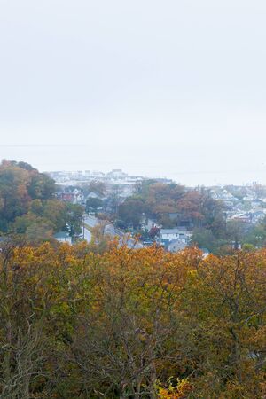 A view of the Highlands in Monmouth County and Sandy Hook as seen from the Twin Lights of the Atlantic Highlands in Autumn on a foggy day.の写真素材