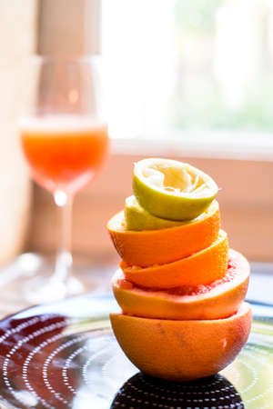 citrus fruit squeezed in the kitchen stacked peels to form a tower, citrus juice vitaminの写真素材
