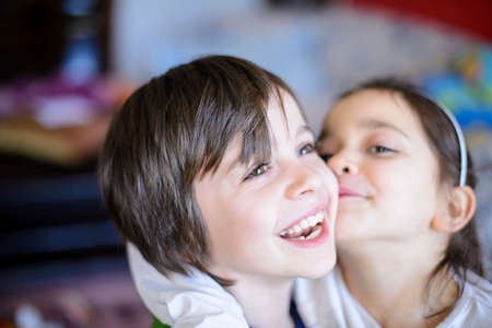 Girl pecking the boy on the cheek.の写真素材