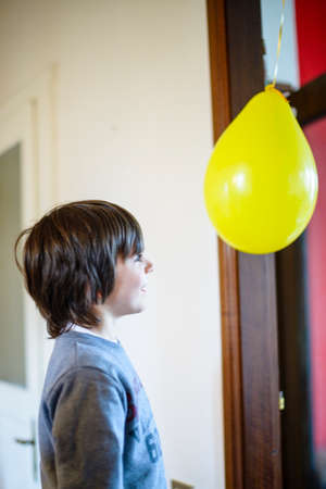 child looks happy balloon for birthday party in his homeの写真素材