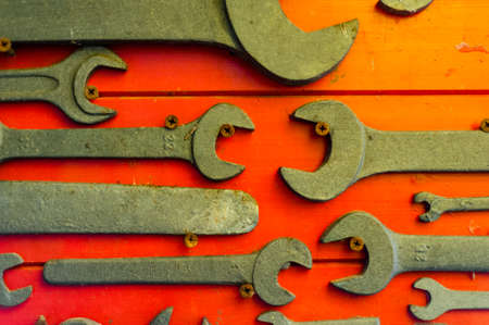 old and used english keys on red backgroundの写真素材