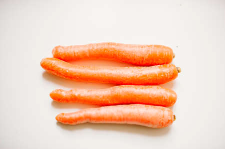 still-life photograph of carrots on white background