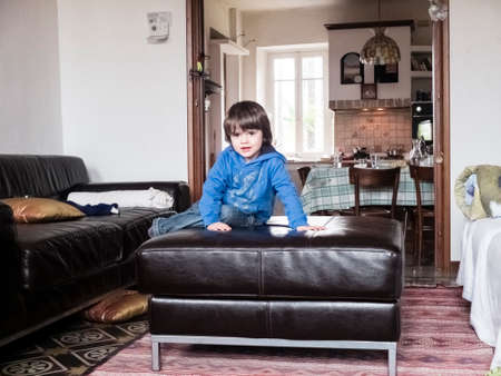 Children play on the sofa in the living roomの写真素材