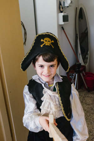 portrait of smiling child dressed as a pirate at homeの写真素材