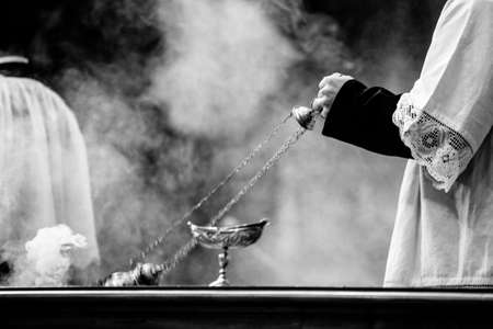 altar boy of the catholic church with thurible in his hand during a celebration, Romeの写真素材