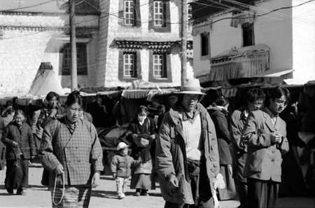 China-Tibet-Lhasa-December 2002 pilgrims walking around the sacred temple of Jokhang black and white photoのeditorial素材