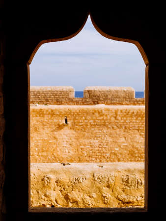 Borj El-Kebir Ottoman Fortress, detail view of Arabic style windows carved in the red stones of the fortress, Mahdia, Tunisiaの写真素材