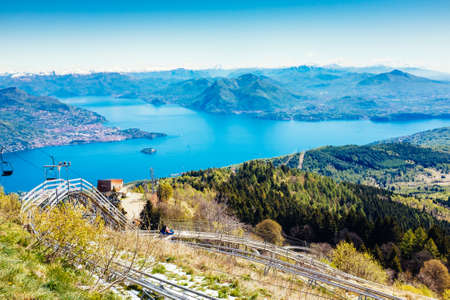 Roller coaster, bob on tracks, in the background Maggiore Lake, Mottarone, Stresa, Italyの写真素材