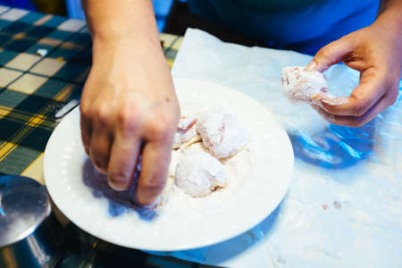 hands prepare pieces of meat, put into flour to be cooked,at homeの写真素材
