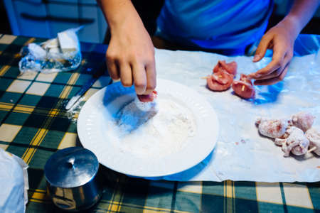 hands prepare pieces of meat, put into flour to be cooked,at homeの写真素材