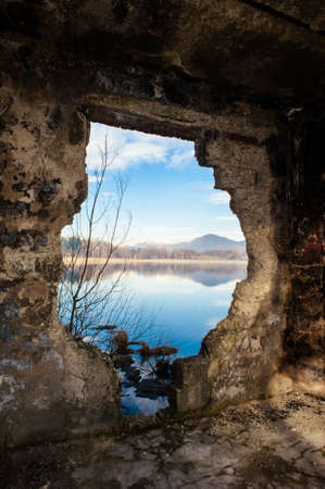 landscape of Lake Varese, through a broken wall,Varese,Lombardy,Italyの写真素材