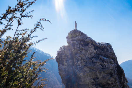 statue of the most holy Virgin Mary over a rock, bathed in rays of sun from the skyの写真素材