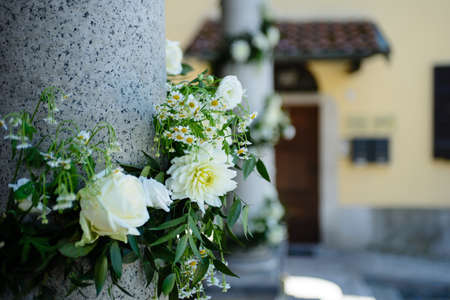 marble column decked out with white flowers for wedding celebrationの写真素材
