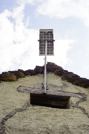 mountain hut with solar panel on the roof for clean and renewable energyの写真素材