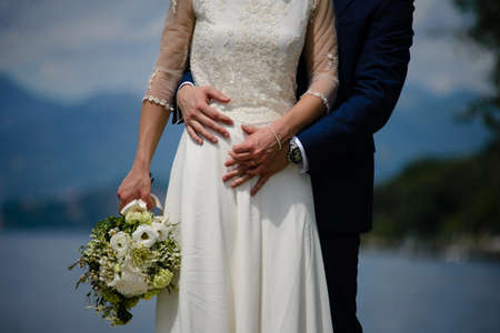 newly married couple with bouquet of flowersの写真素材