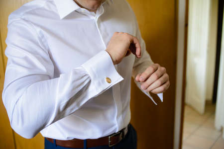 elegant man with white shirt and gold cufflinks