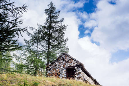 mountain house with flowers on the windows in the nature,Alpe Devero,Italyの写真素材