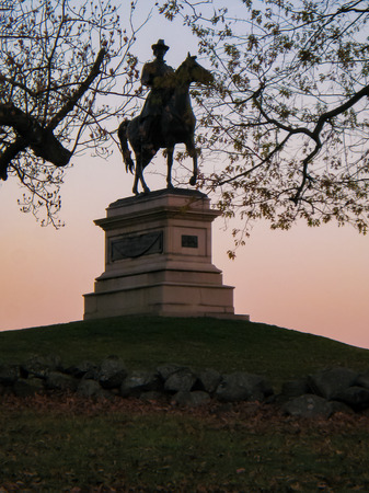 Gorgeous sunset silhouetting the statue of Union Major General Winfield Scott Hancock at Gettysburg National Park in Pennsylvania (USA).のeditorial素材
