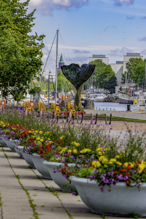 TURKU, FINLAND - July 5, 2018: A beautiful Whale Tail fountain sculpture created by Achim Kuehn and called Harmonia rises from the Aura River.のeditorial素材