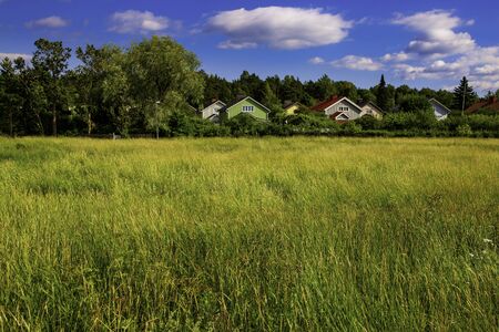 Colorful wooden homes nestled among lots of greenery in a suburb of Turku, Finland.の写真素材