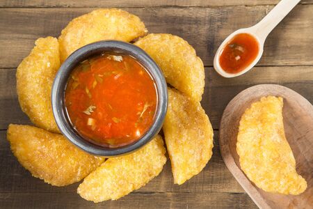 Colombian empanada with spicy sauceの写真素材