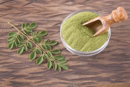 Fresh leaves and moringa powder - Moringa oleifera. Top viewの写真素材