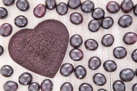 Acai powder and berries - Euterpe oleraceaの写真素材