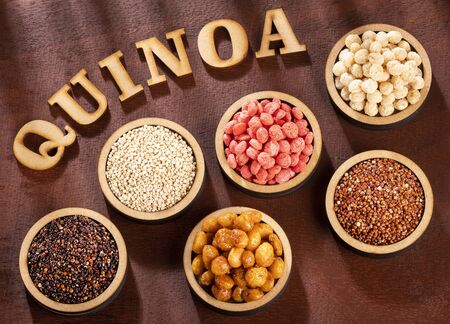 Seeds of white, red and black quinoa - Chenopodium quinoa. Wood backgroundの写真素材