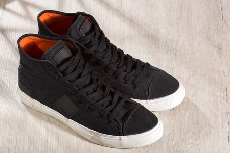 A pair of black sneakers with white rubber