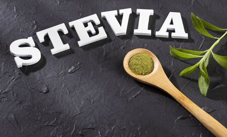 Stevia - stevia rebaudiana plant, green leaves and crystals in a wooden spoonの写真素材