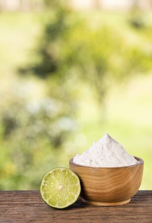 Baking soda with lemon. Wooden table in the park among the trees on a summer day.の写真素材