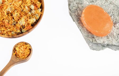 Dried calendula flowers with handmade soap - Calendula officinalis. White backgroundの写真素材