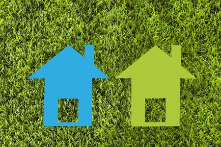 Paper house on green grass - Ecological conceptの写真素材