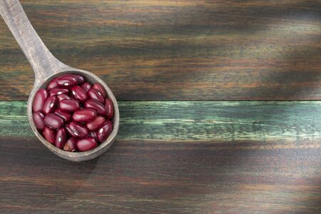 Raw red beans in wooden spoon - Phaseolus vulgarisの写真素材