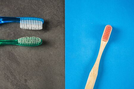 Natural bamboo toothbrush and other plastic toothbrush. Concept of sustainable lifestyle.