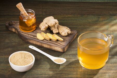 Healthy drink of ginger, lemon and honey - Zingiber officinale. Wood backgroundの写真素材