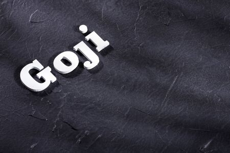 Word goji in wooden letters - Lycium barbarum